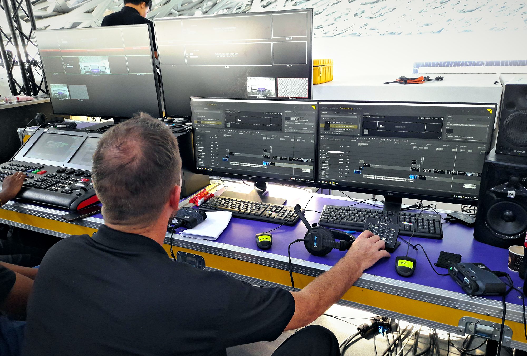 DMS operator running Pixera playback timelines at the video control desk